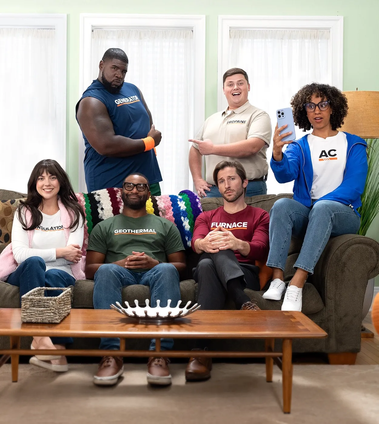 A group of men and women gathered in the living room.