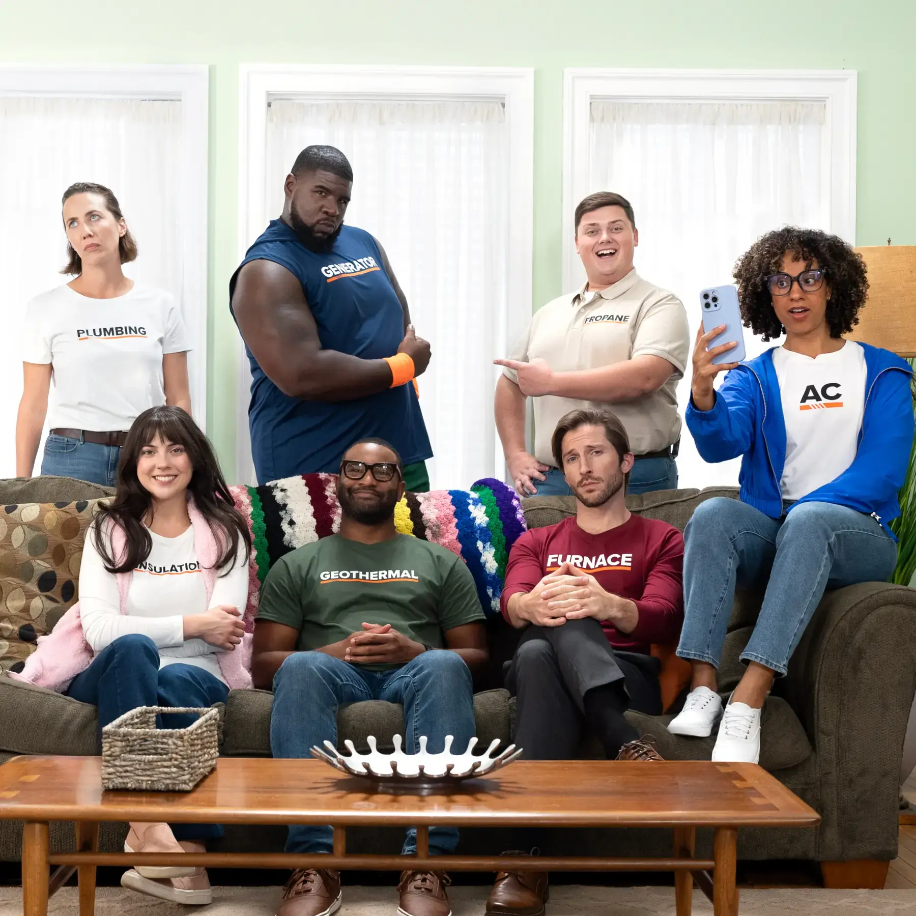 A group of men and women gathered in the living room.